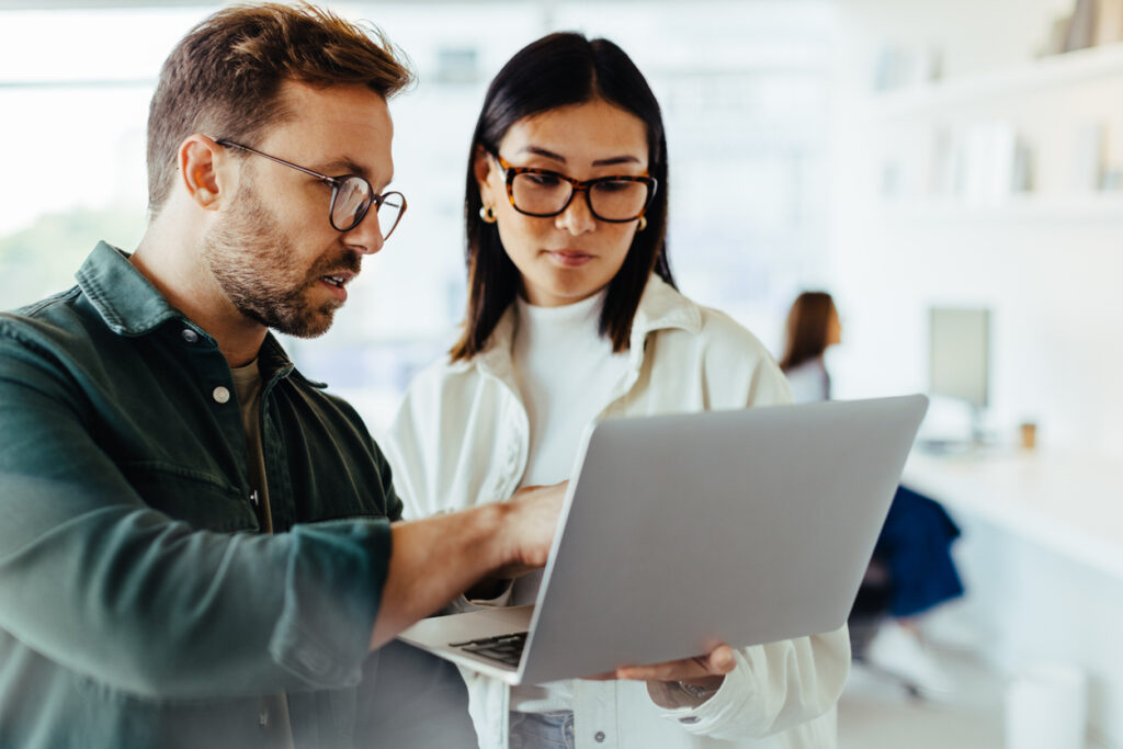 Two young business people discussing a project.