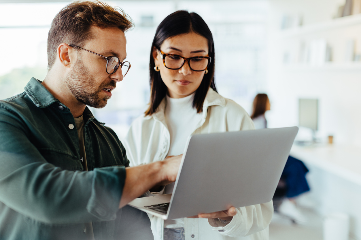 Business people having discussion and using computer.