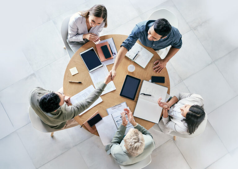 Conference table with people illustrating collaboration and positive culture