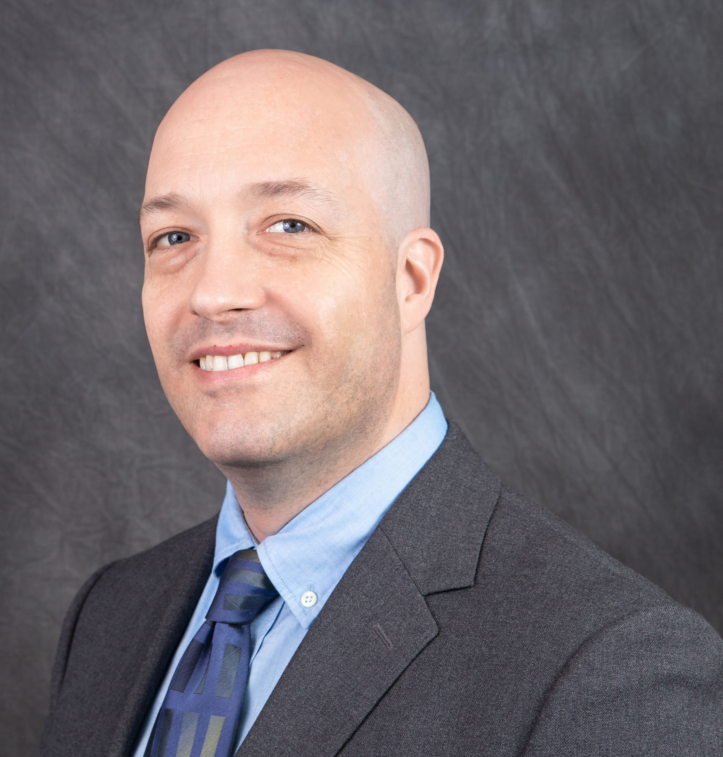 Headshot of Michael Caskey in suit and tie