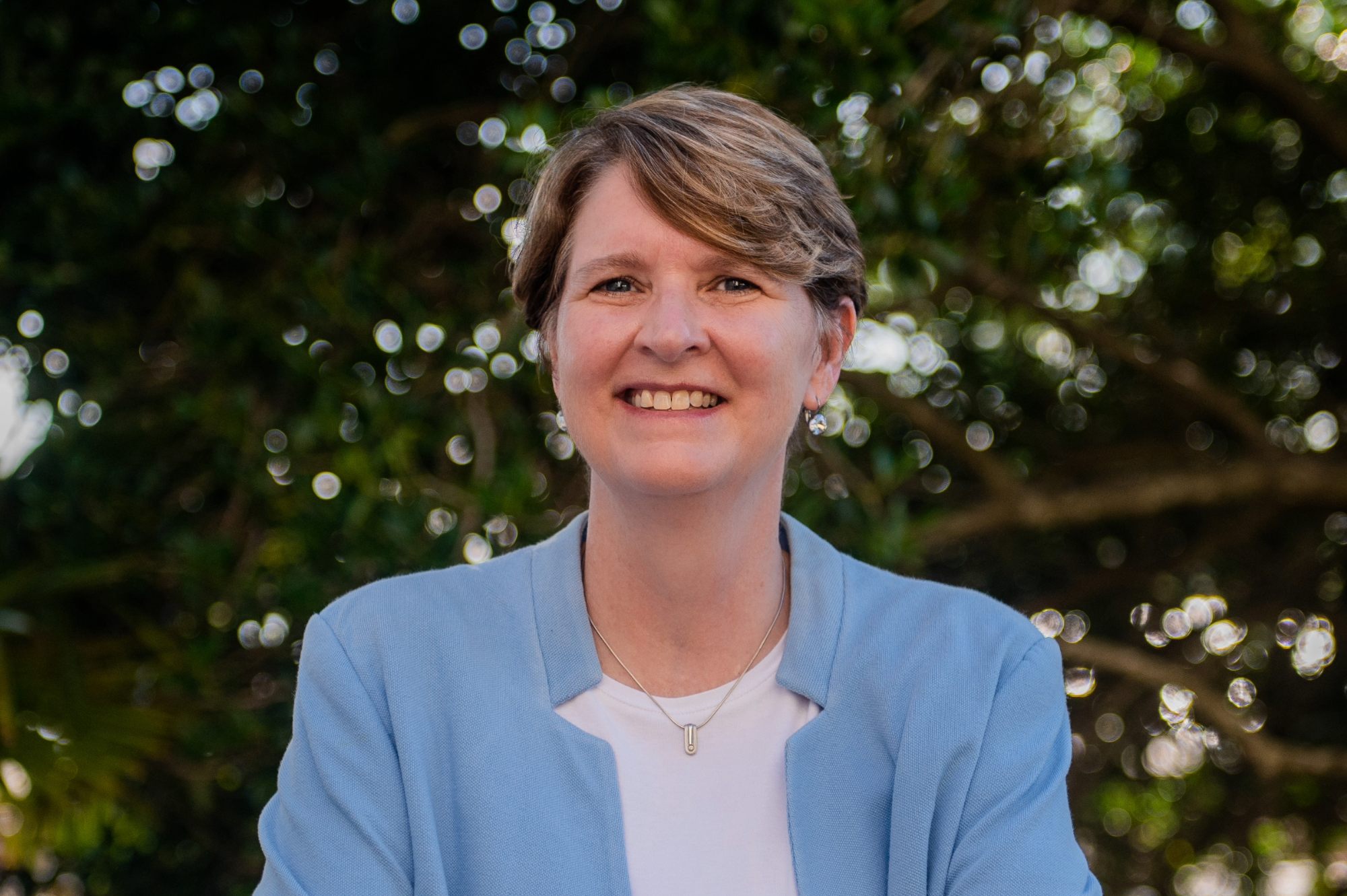 Allison Crumpler with blue suit and white shirt